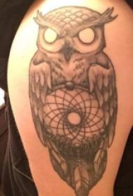 Tattoo owl boy with black ash tattoo picture on arm