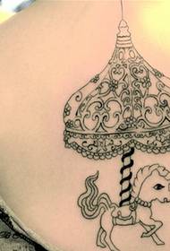 A female back carousel tattoo pattern picture