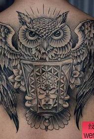 Back black and white owl tattoo work