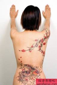 Woman's back seductive peach birch tattoo pattern