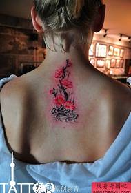 Beautiful plum colored tattoo pattern on the back of the girl