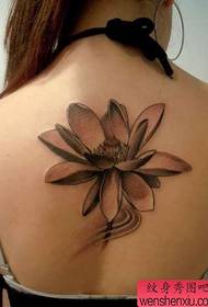 Beautiful black and gray lotus tattoo pattern on the back of the girl