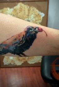 Arm with a painted bird and berry tattoo pattern