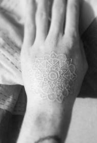 Mooi wit onzichtbaar vanille tattoo-patroon op de rug van de hand