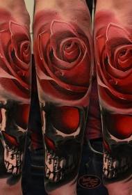 Arm realistic color human skull with rose tattoo