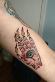Boy painting arm on gradient flame hand and eye tattoo picture