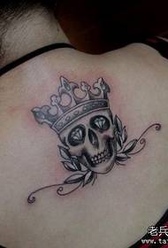 Girl's back is beautifully popular wearing a crown skull tattoo pattern
