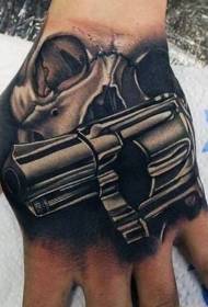 Hand black realistic skull with pistol tattoo pattern