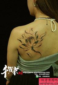 Beautiful female lotus tattoo pattern on the back of the girl
