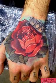 a beautiful rose tattoo on the back of the hand