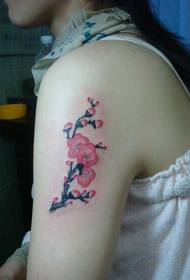 Beautiful woman's arms on a beautiful plum tattoo pattern