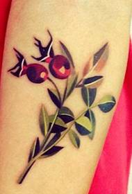 A picture of a cherry tattoo on the arm