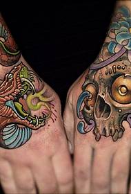 a school-style snake tattoo on the back of the hand