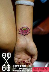 Girls' wrists, small and delicate pink lotus tattoo pattern