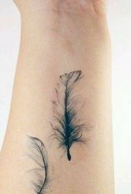 a woman's wrist feather tattoo pattern