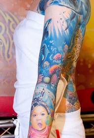 Very cute child tattoo picture on the flower arm