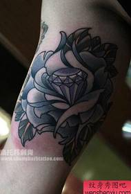 Exquisite diamond and rose tattoo pattern on the inside of the arm