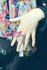 Cute little bow finger tattoo picture