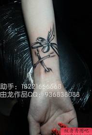 Female wrists beautiful black and white bow tattoo pattern