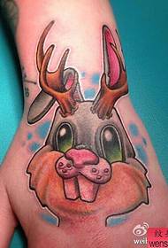 a cute rabbit tattoo on the back of the hand
