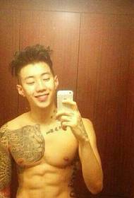Super narcisoidni mladić koji pokazuje svoju tetovažu s pol oklopa