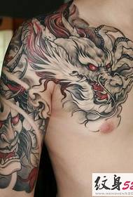 Domineering over the shoulder dragon half tattoo