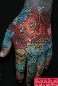 a nice looking lucky cat tattoo on the back of the hand