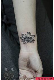 Beautiful black and white lotus tattoo pattern on the wrist of girls