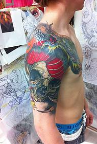Italian tattoo artist Daniele Trabucco's half-armed dragon tattoo