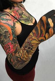 Flower arm with god's personality skull tattoo pattern