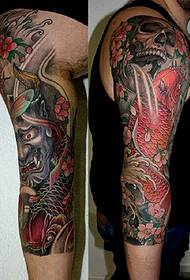 Greek tattoo artist KOSTAG's squid-like flower arm tattoo
