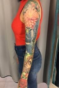 Girl's arm painted plant material flowers and bird flower arm tattoo pictures