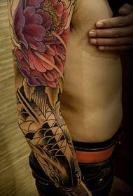 Flower arm tattoo picture of Dudan flower and squid