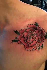 a man's clavicle at a red peony tattoo pattern