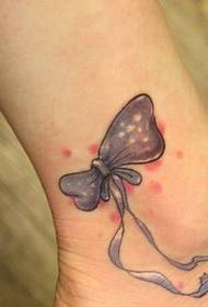 beautiful and fresh bow tattoo on the ankle
