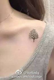 a small tree tattoo pattern at the clavicle