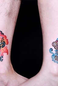 couples feet water fire key tattoo