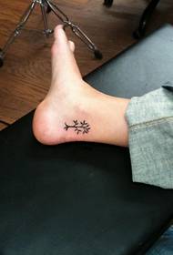 small tree totem tattoo at the ankle
