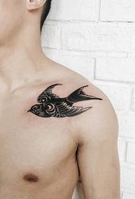 a swallow tattoo picture on the man's collarbone