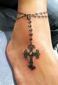 good-looking cross anklet tattoo