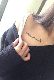 sexy girl with simple English tattoo on the collarbone
