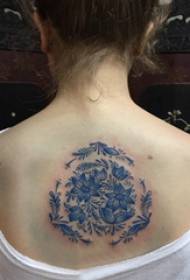 back tattoo female girl on the back of the blue flower tattoo picture