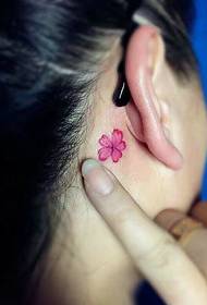a small flower tattoo pattern at the back of the ear is very natural