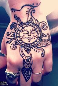 beautiful sun totem tattoo pattern on the back of the hand