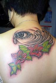 female back realistic eye and flower tattoo