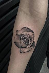an ink rose tattoo pattern on the back of the hand