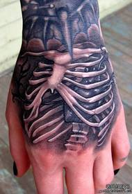 a personalized skeleton tattoo on the back of the hand