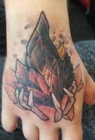 Crystal tattooed male hand on the back of the colored spar tattoo picture