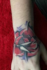 abstract tattoo painting on the back of the boy's hand on the abstract rose tattoo picture