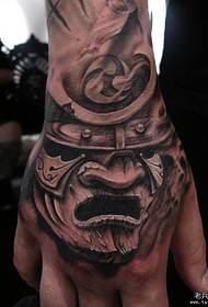 a warrior tattoo on the back of the hand